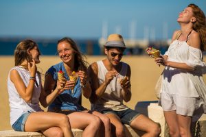 jeunes mangeant une glace sur la plage